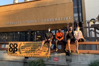 Co-op residents sitting on the rail in front of the BSC