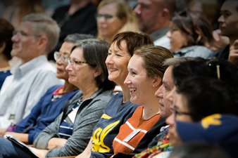 Image of audience members listening to a lecture