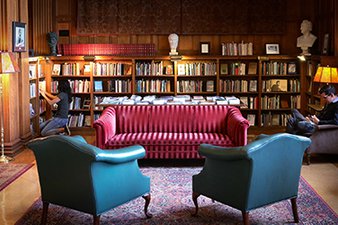 Reading room with comfy furniture. Natural light is lighting up the space.