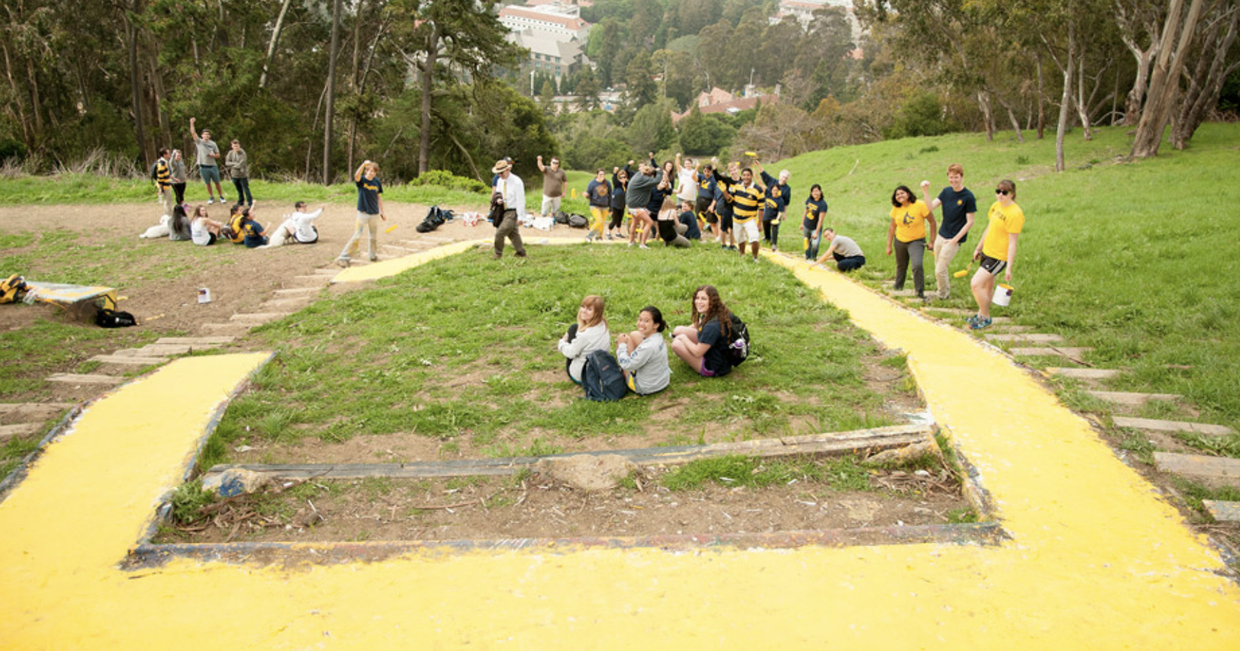 Rally Committee students pose next to a freshly painted Big C on Charter Hill.