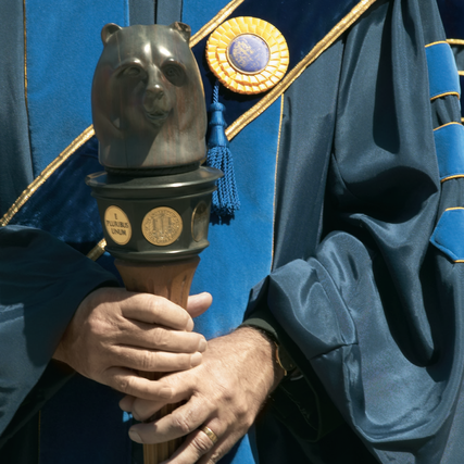 Faculty holding the campus mace