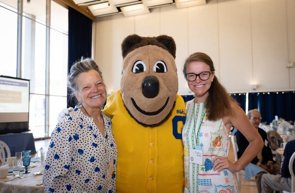 Two women standing with Oski, the UC Berkeley mascot.