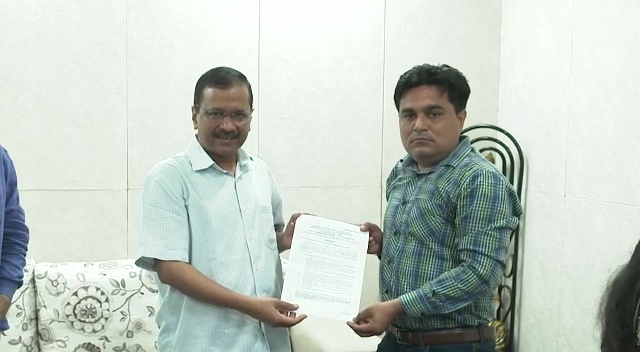 Delhi CM Arvind Kejriwal gives a letter of appointment of a government job in the Education Department to the brother of Intelligence Bureau staffer Ankit Sharma who lost his life during North-East Delhi violence in the year 2020