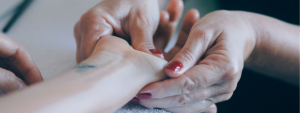 Hand being moisturised to improve nail health