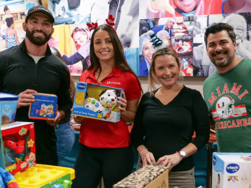 group of people showing toys to the camera