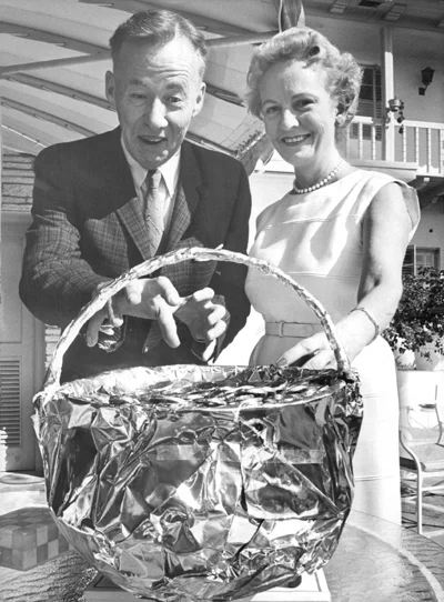 Old picture of man and woman behind a basket