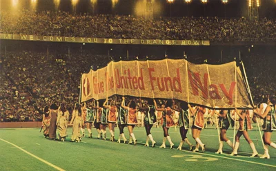 Old picture of a Football team holding a banner with the phrase 