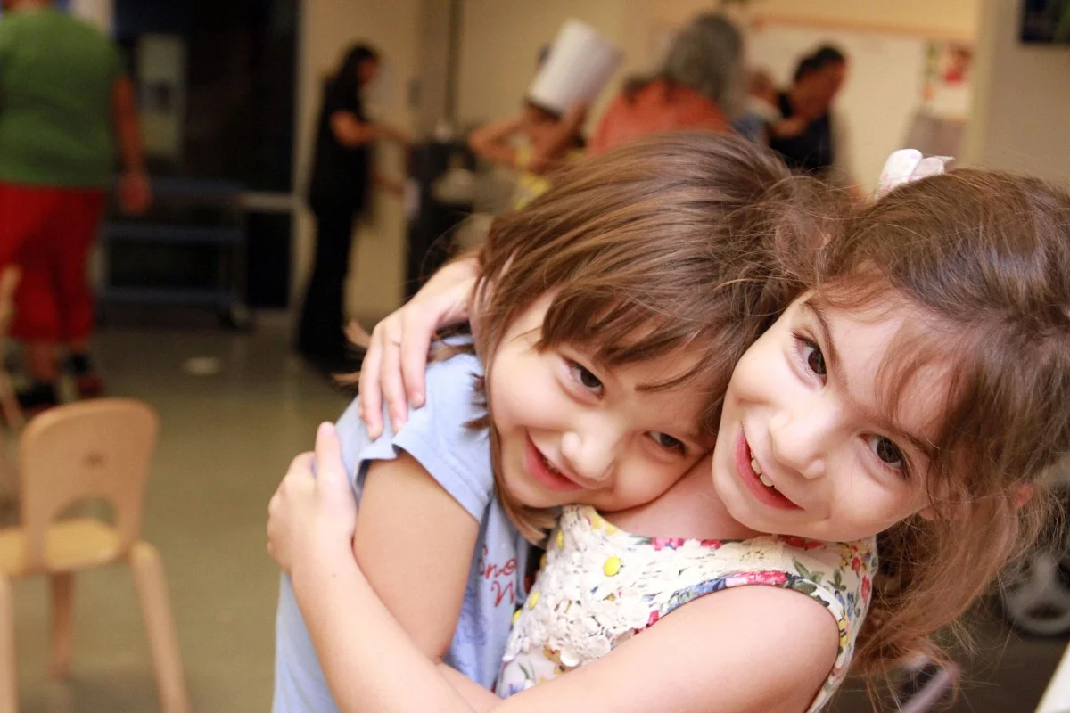 Two children hugging