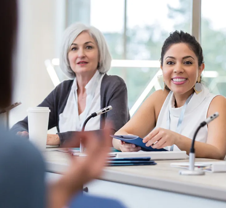 women talking in boardroom