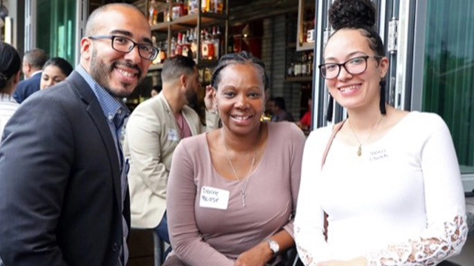 three people smiling and posing