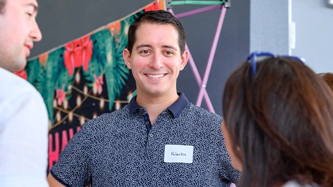 red-handed man smiling at the camera