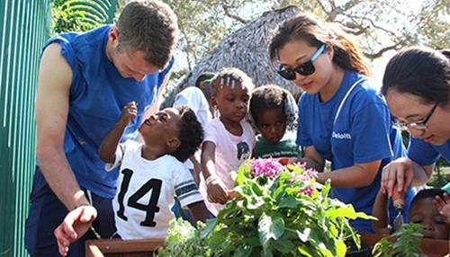 adults planting with children