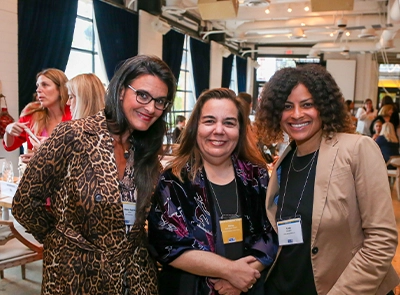 three women smiling and posing for the camera