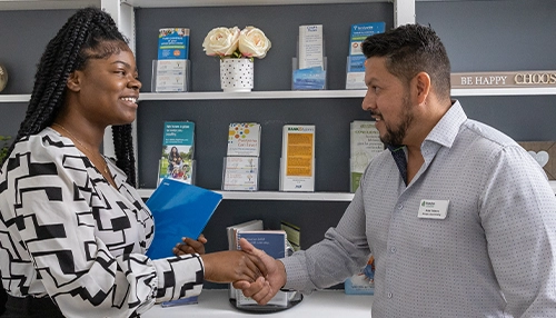 man and woman shaking hands in an office