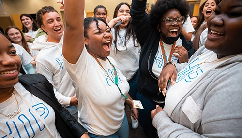 Group of young adults smiling and cheering