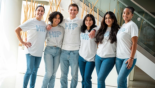 Group of young adults smiling and looking at the camera