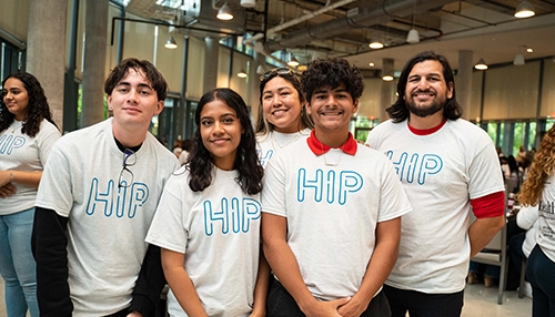 Group of young adults smiling and looking at the camera