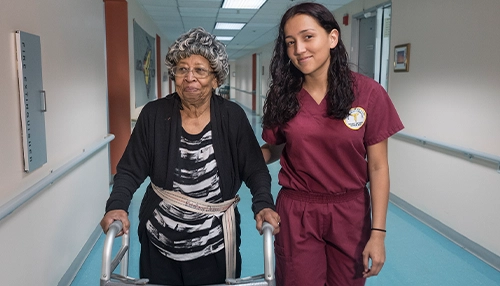 female doctor walking with an older adult