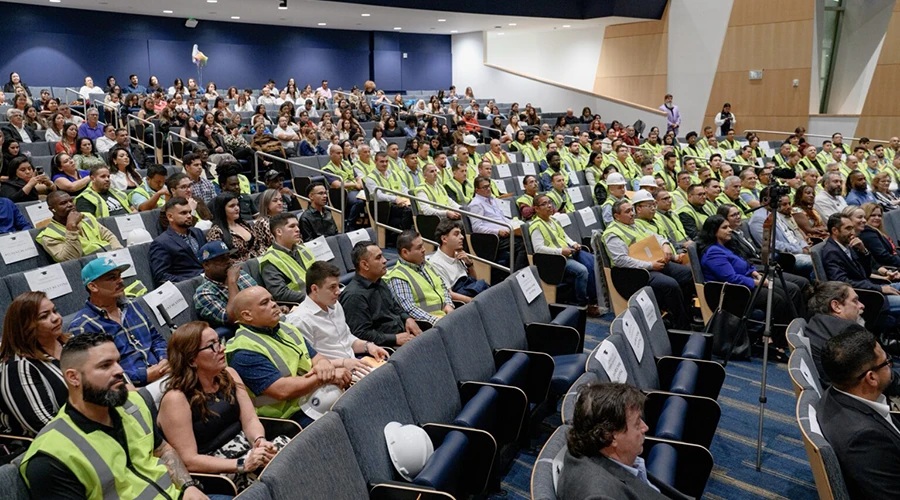 A large group of people sitting in an auditorium