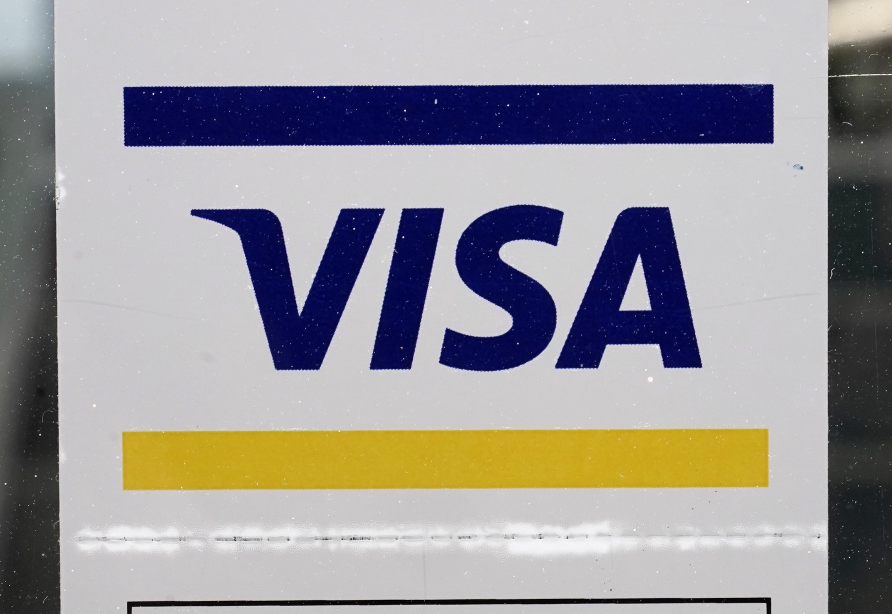 A Visa sign is displayed on the front door of a local business, April 27, 2021, in Urbandale, Iowa. Visa has announced major changes to how its credit and debit cards will operate in the U.S. Features in the works will lead to Americans to carry fewer physical cards in their wallets and make the 16-digit credit or debit card number printed on every physical card increasingly irrelevant. The new features unveiled Wednesday, May 15, 2024 will be some of the biggest changes to how payments operate since the U.S. rolled out chip-embedded cards several years ago. (AP Photo/Charlie Neibergall, file)