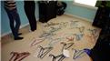 Most Hangers Hung On A Body While Holding Four Twizzlers In Mouth