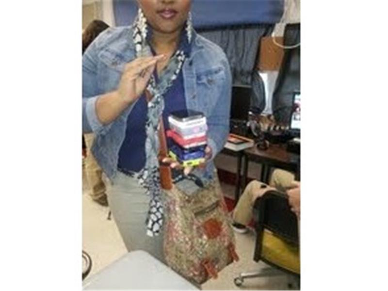 Most iPhones Held In Hand At Once 