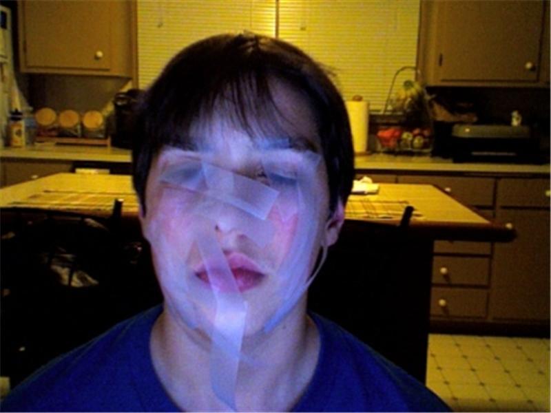 Most Pieces Of Tape Taped To Face At Once