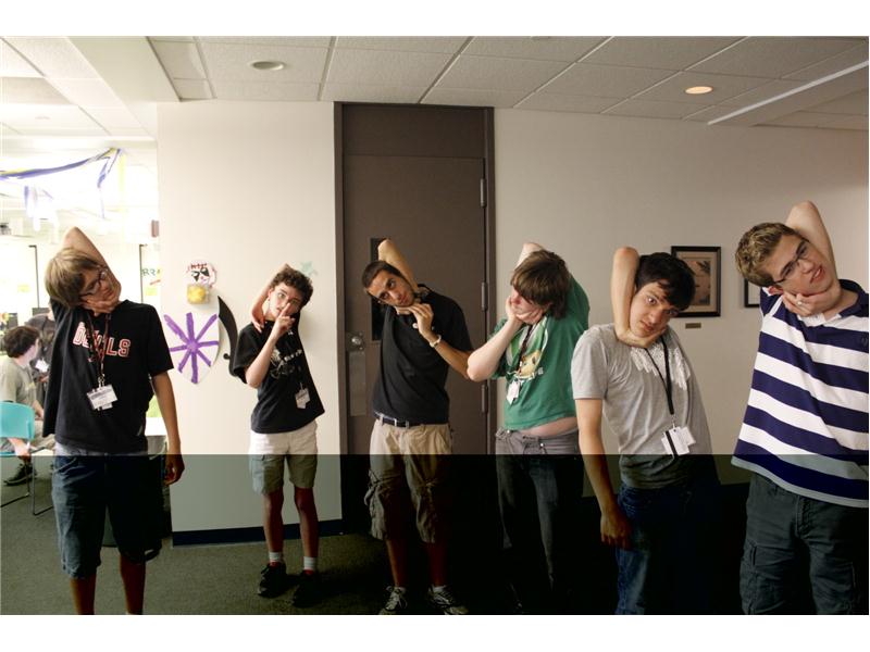 Largest Group Of People Wrapping Arm Around Head To Touch Ear