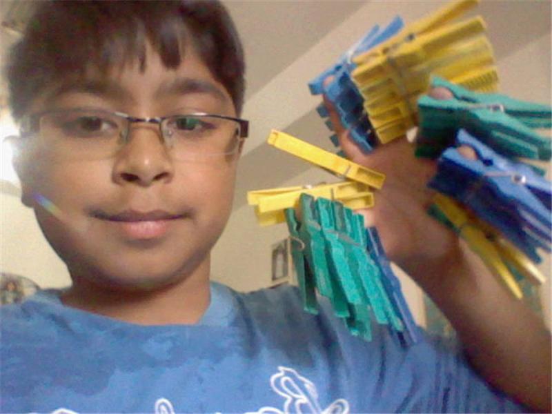 Most Clothespins Attached To Hand