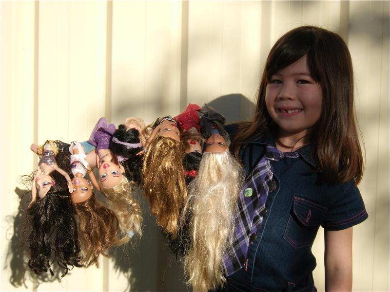 Most Bratz Dolls Balanced On Arm At Once