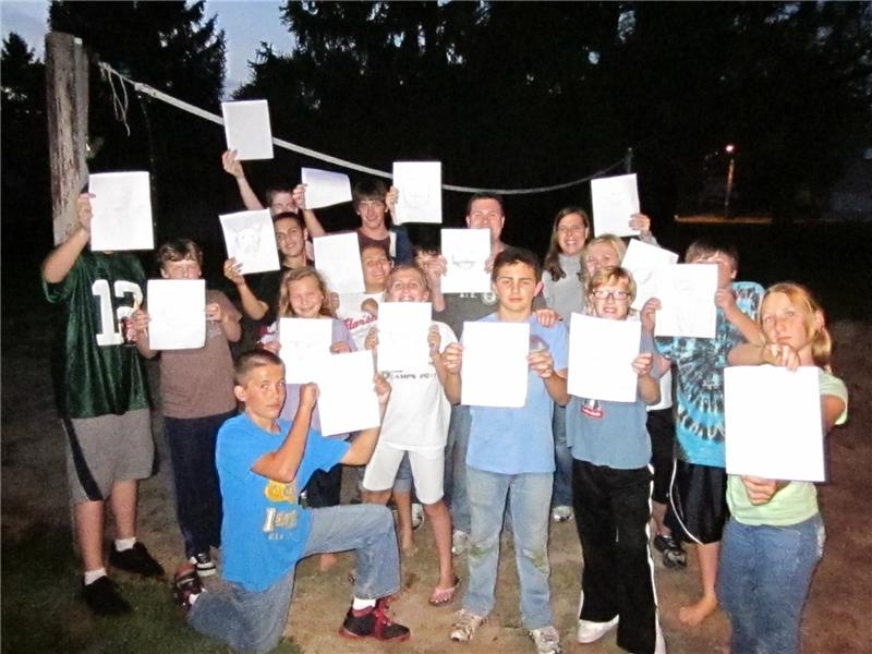 Most People Holding Their Own Sketches Of Chuck Norris While Standing On A Sand Volleyball Court 