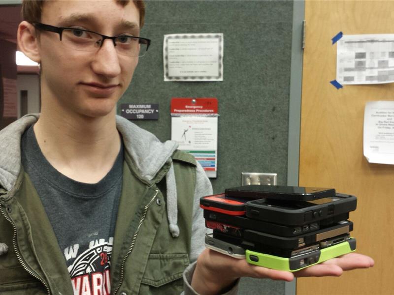 Most iPhones Held In Hand At Once 