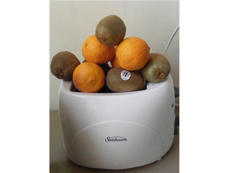 Most Pieces Of Fruit Balanced On A Toaster