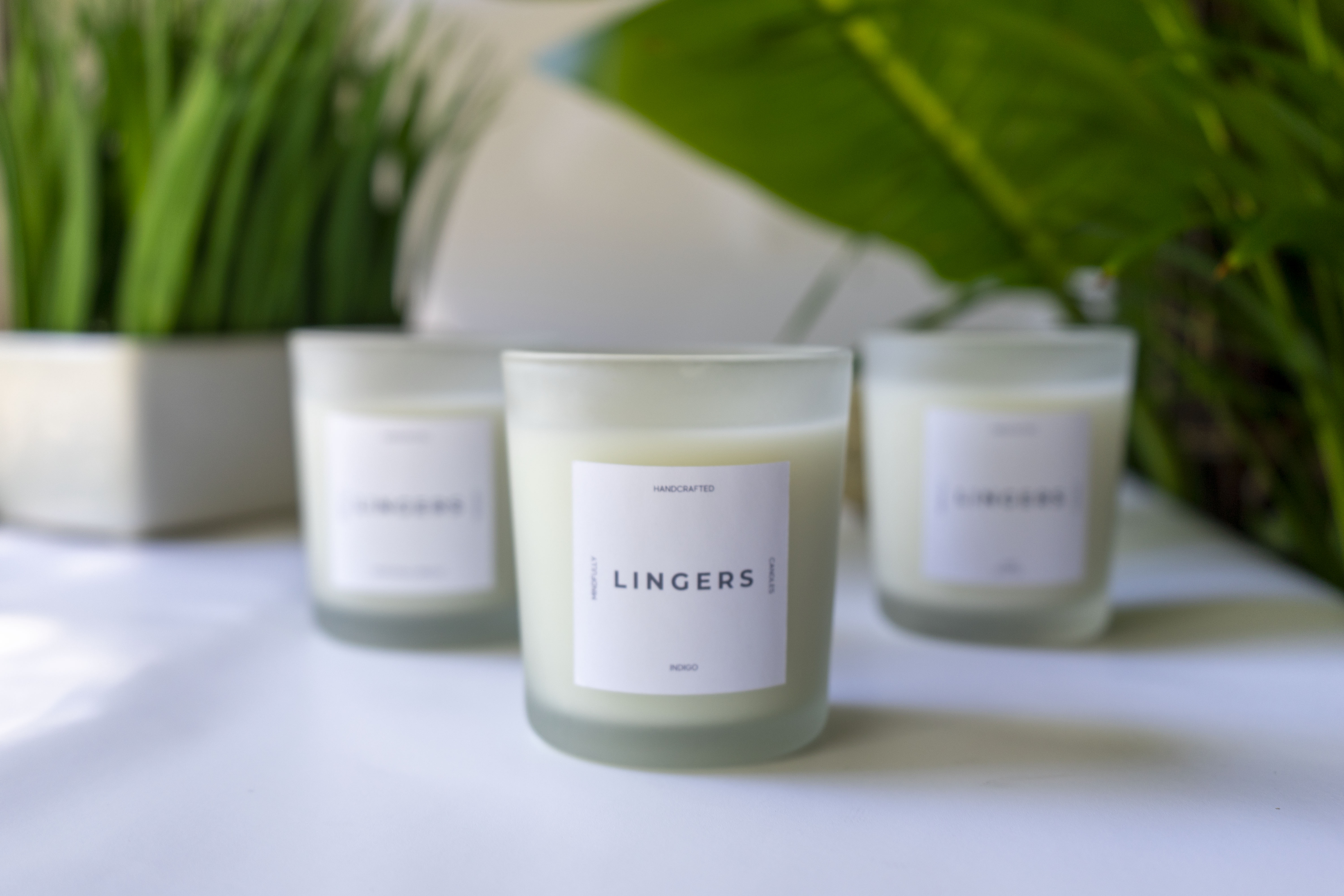 The logo or business face of "LINGERS Candles"