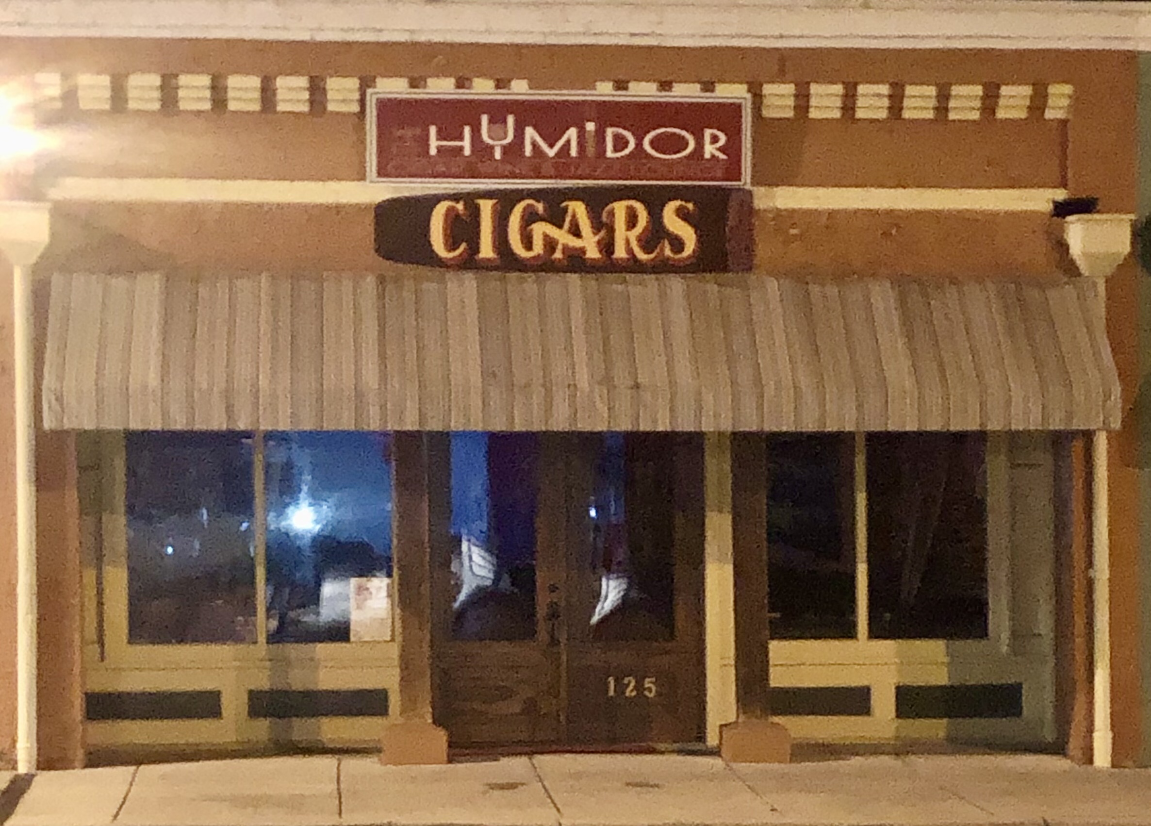 The logo or business face of "The Humidor Cigar, Wine & Jazz Lounge"