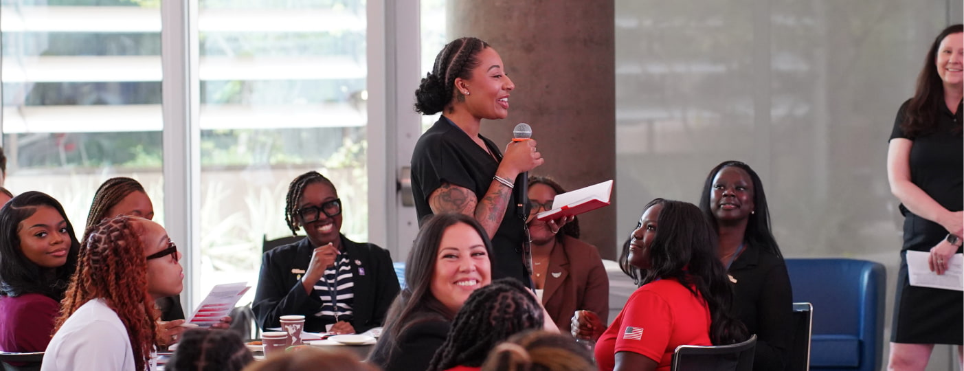 A woman stands in the audience and asks a question