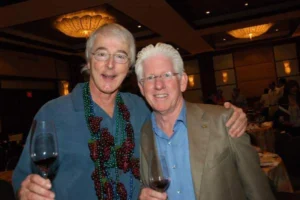 two men embraced posing and smiling at the camera