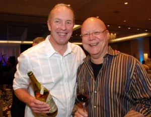 two men posing and smiling at the camera