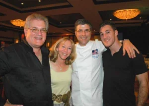 four people smiling and posing to the camera
