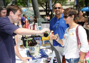 man serving wine to woman