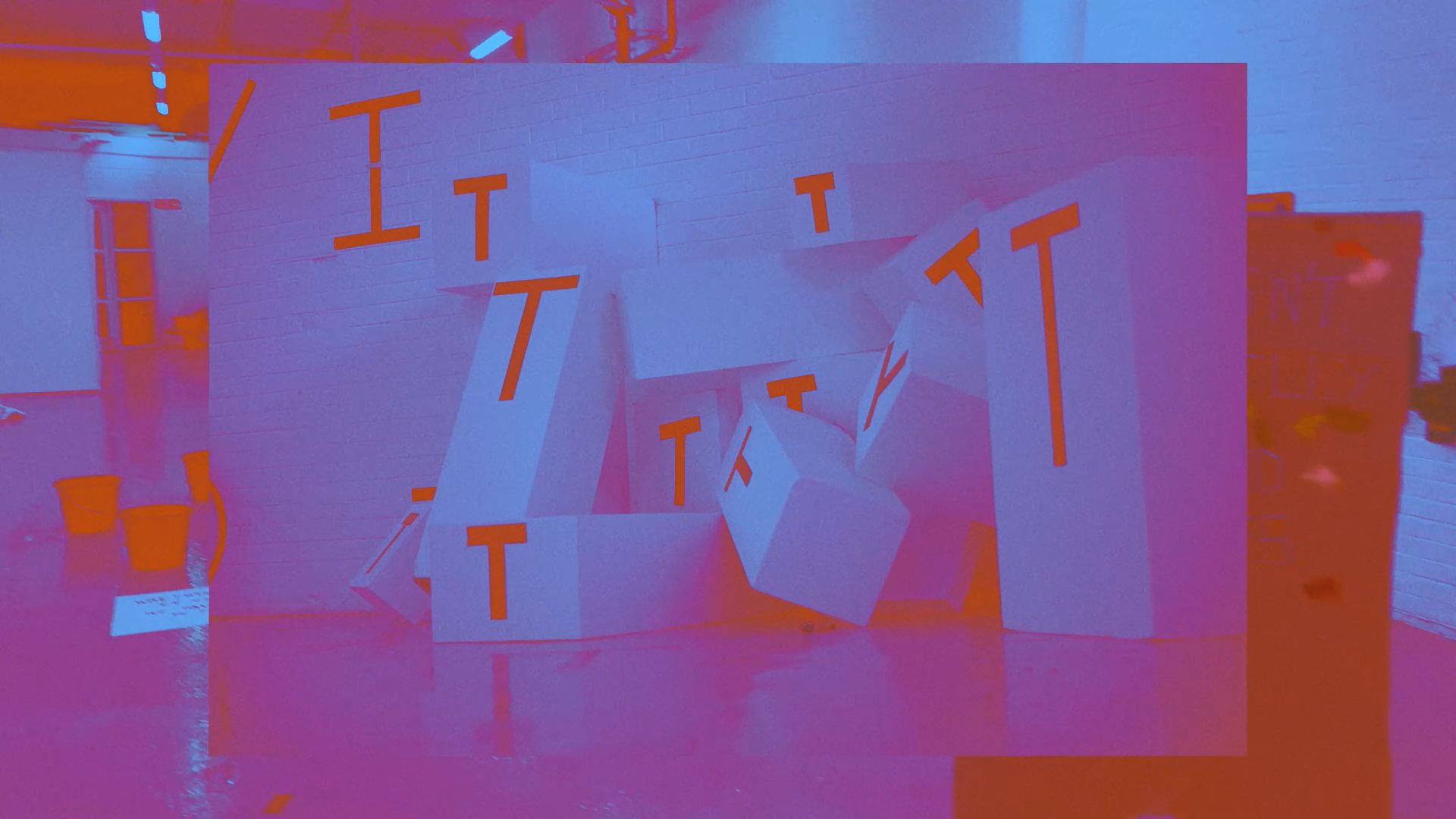 A purple and red tinted image made of layered photographs, with the top photograph depicting a pile of square blocks printed with the letter t