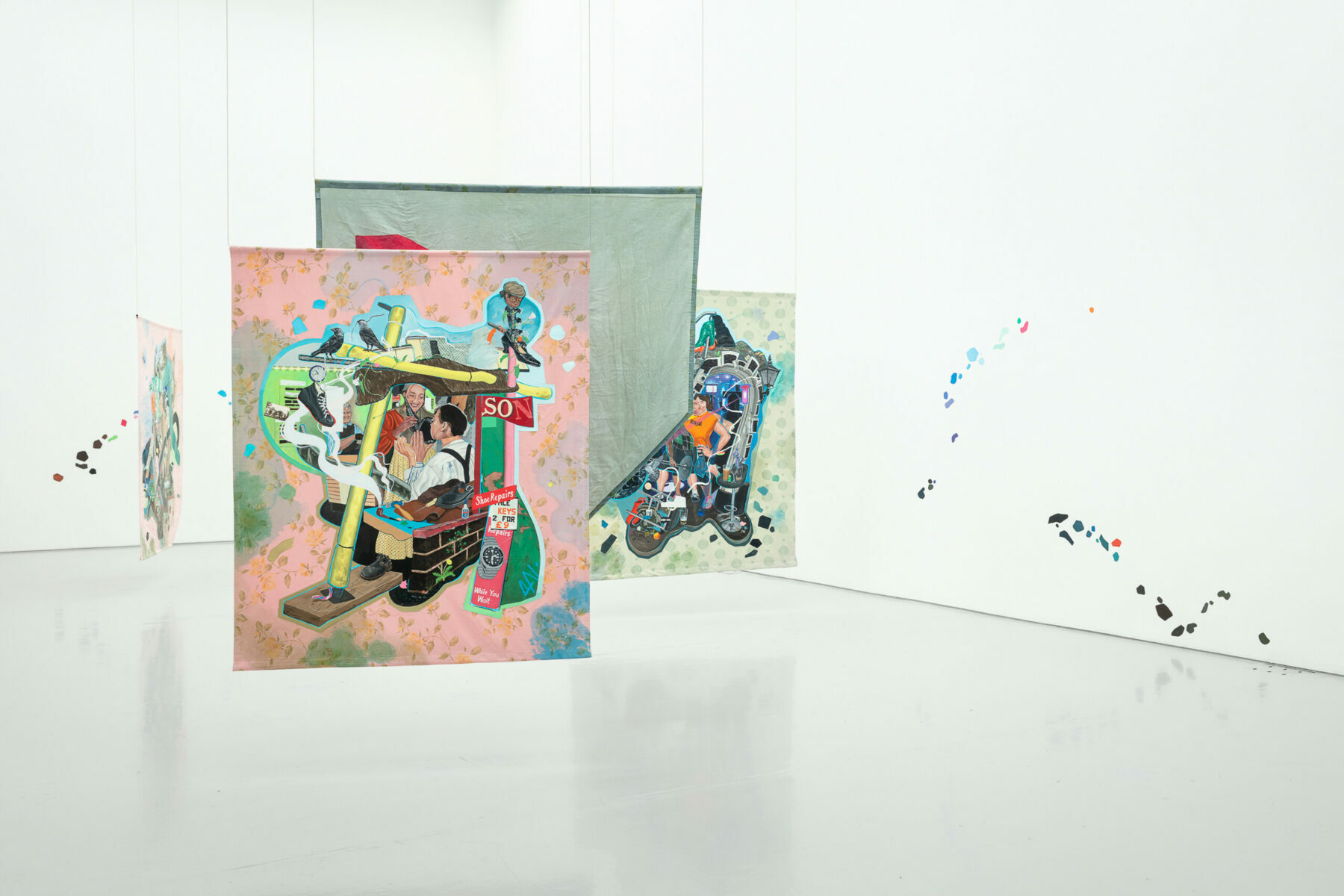 Four figurative paintings hung in the centre of a gallery space, which has small colourful painted shapes on the wall.