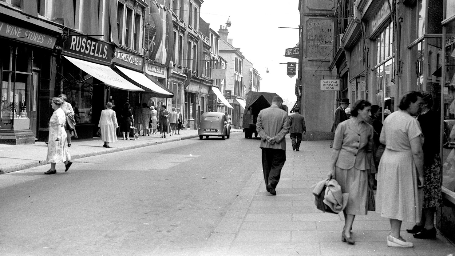 A black and white image showing a street scene