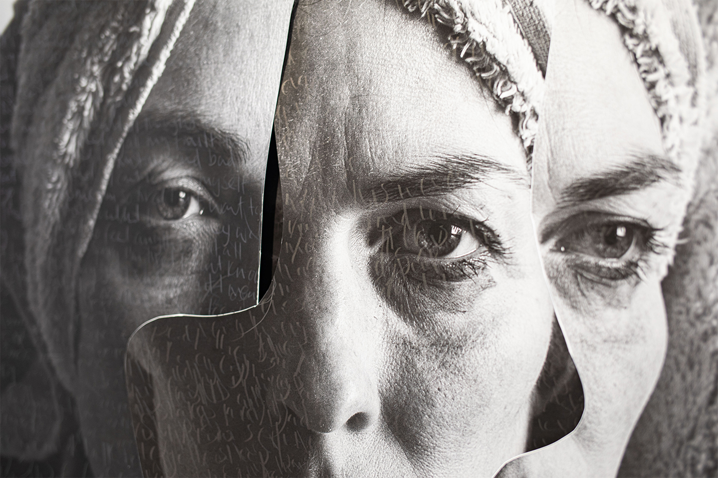 A close up of a layered collage of three black and white photographic self-portraits of a woman.