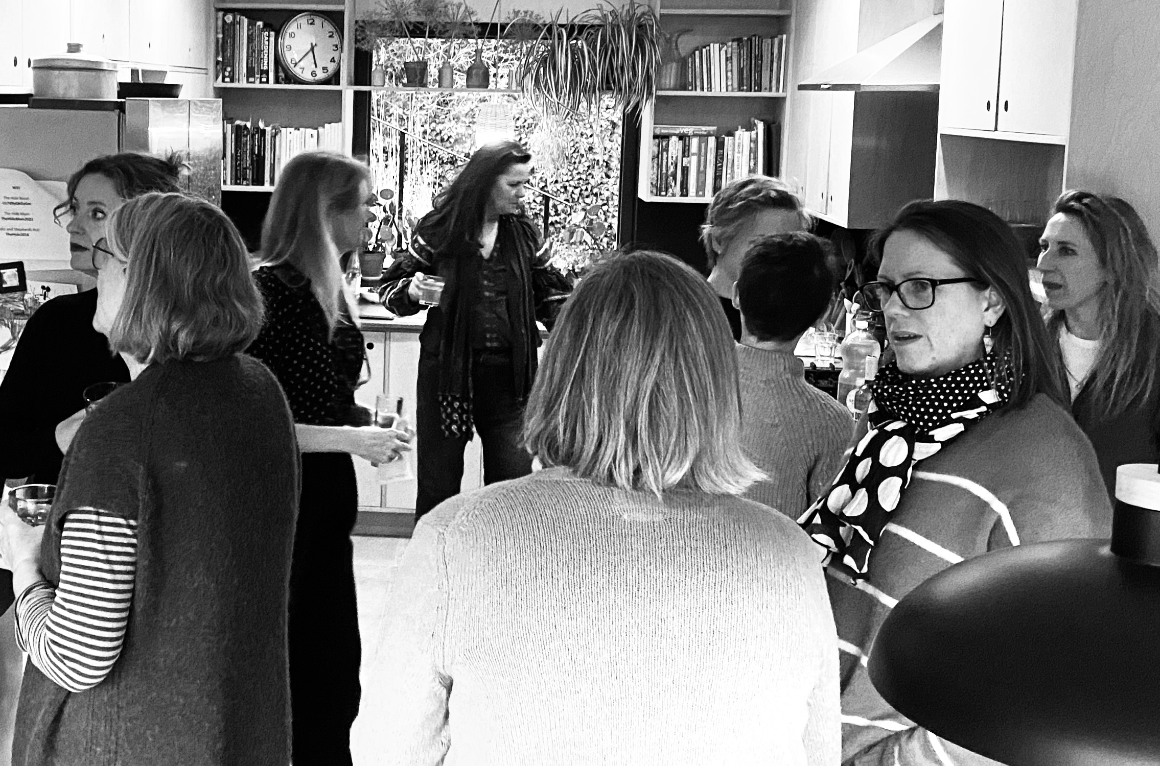 People grouped together in an interior for a talk with a speaker