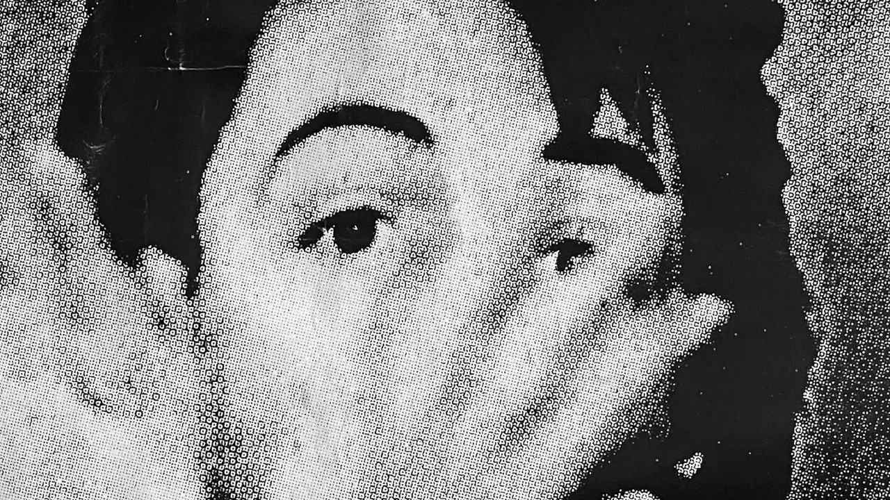 vintage film still of close up portrait of John Smith with hands over his face.