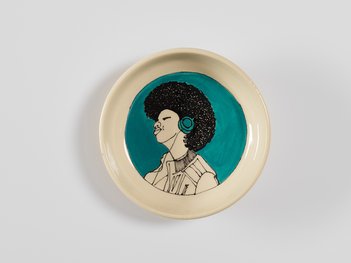 Small dish with illustration of person wearing headphones