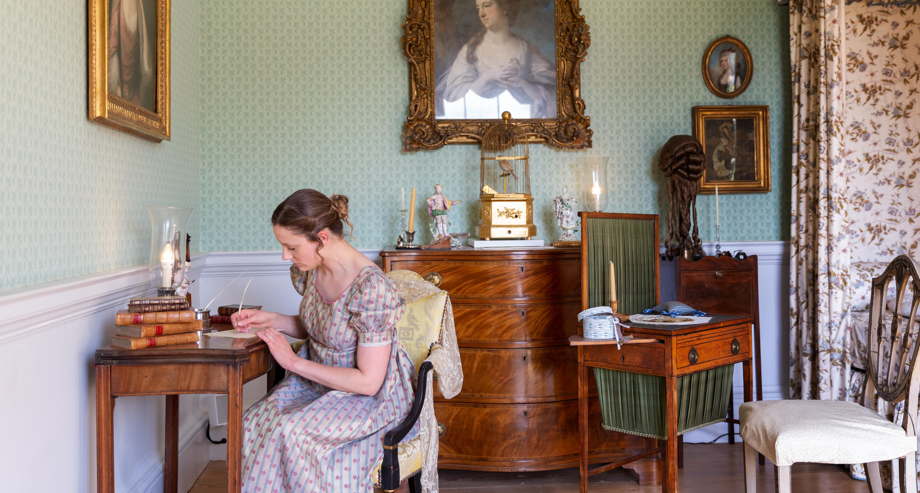 A women writing at a desk