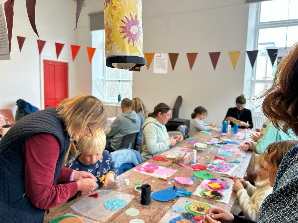 room full of people making at a large table