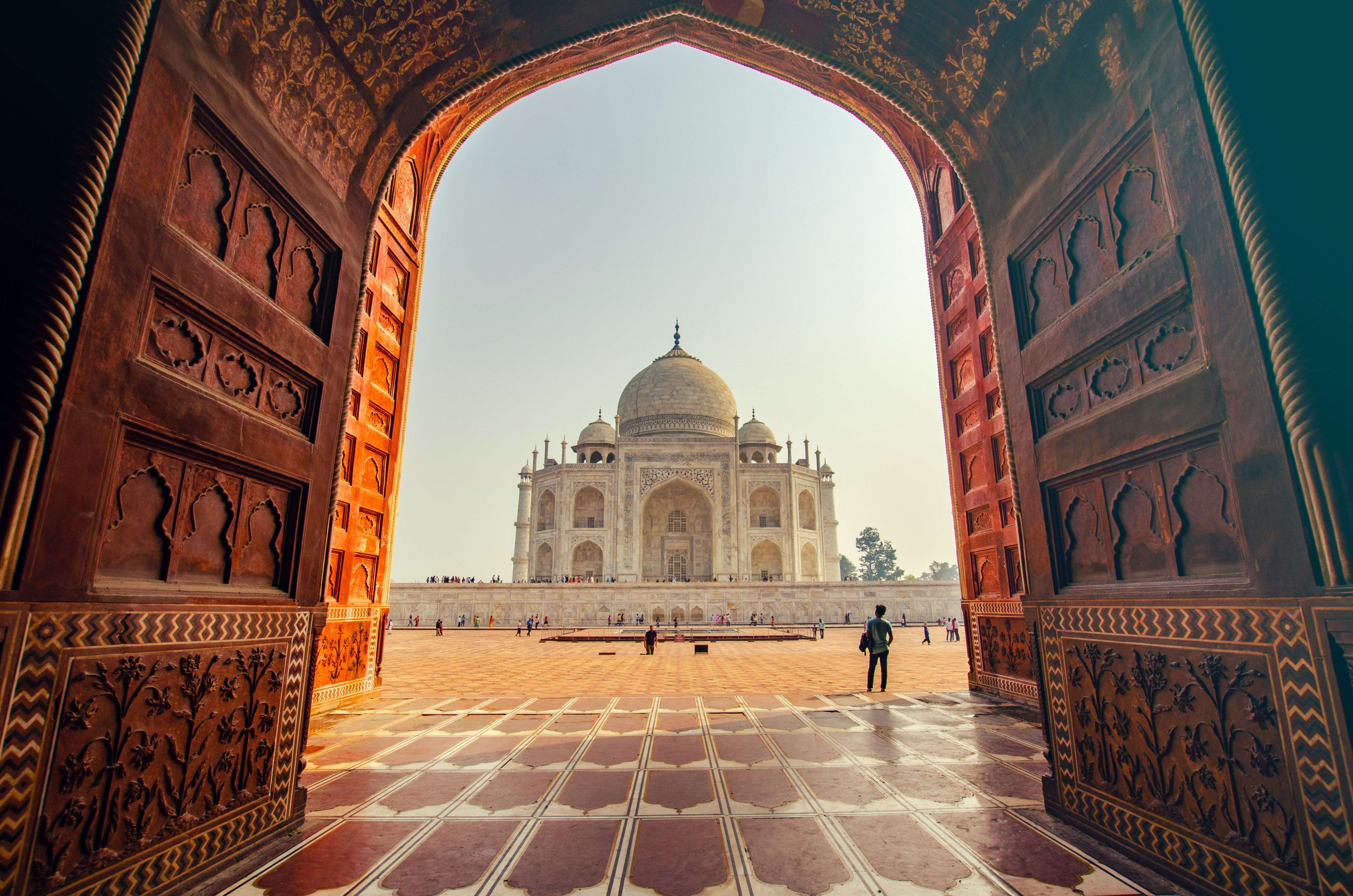 Entrance to the Taj Mahal with man in walkway